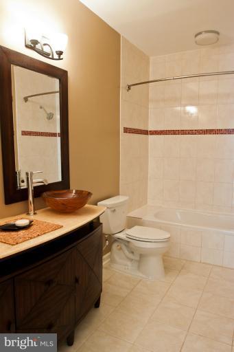 1917 2nd Street Northeast, Unit 201 Washington, DC 20002 - Photo 14 of 23 a bathroom with a granite countertop sink toilet and mirror