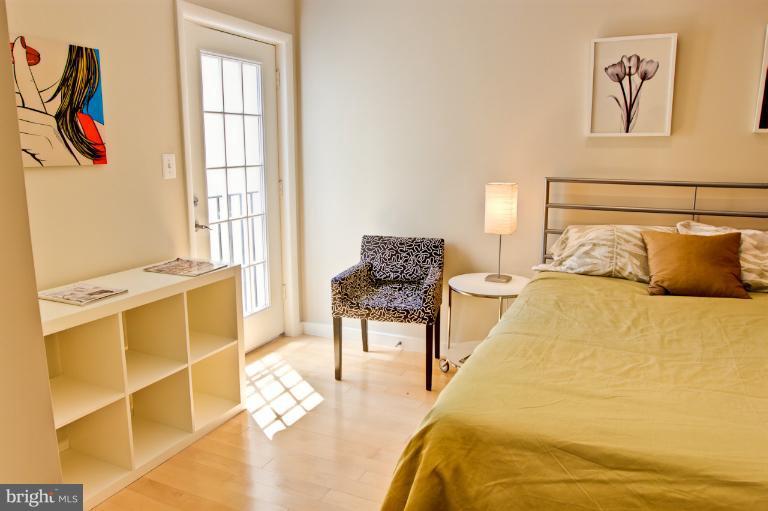 1917 2nd Street Northeast, Unit 201 Washington, DC 20002 - Photo 18 of 23 a bedroom with a bed and a window