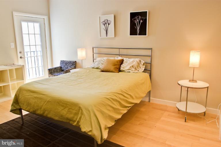 1917 2nd Street Northeast, Unit 201 Washington, DC 20002 - Photo 6 of 23 a bedroom with a bed and a table