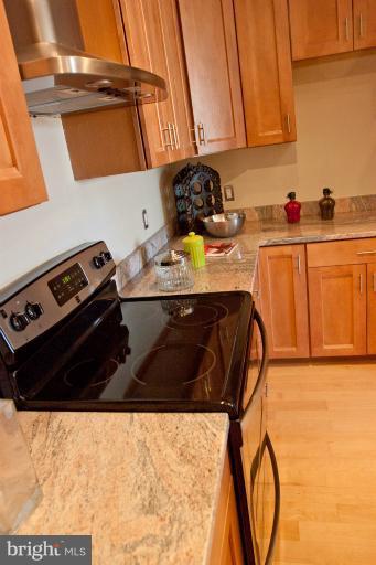 1917 2nd Street Northeast, Unit 201 Washington, DC 20002 - Photo 7 of 23 a kitchen with a stove and a refrigerator