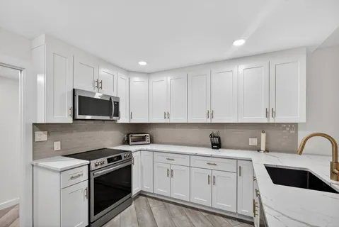 a kitchen with a sink and cabinets