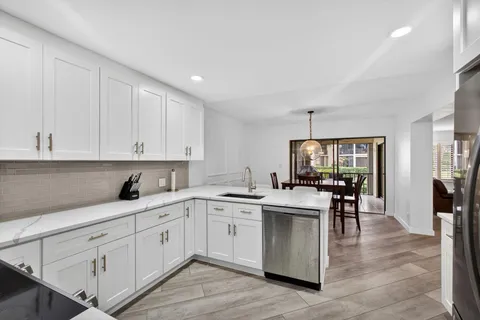 a kitchen with stove a sink and cabinets