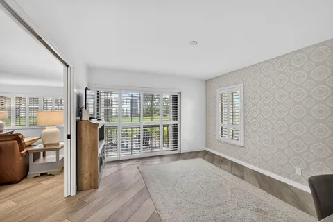 a living room with furniture and a dining table with kitchen view