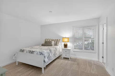a bedroom with a bed and window