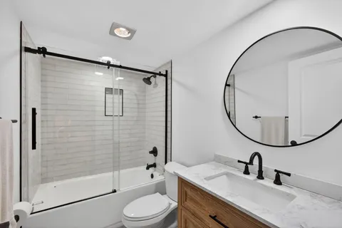 a bathroom with a sink toilet and shower