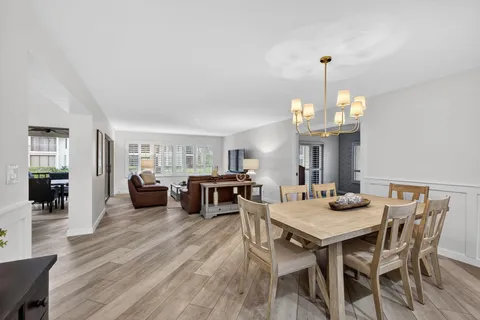 a view of a dining room with furniture and chandelier