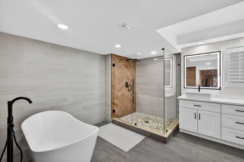 a bathroom with a bathtub and shower