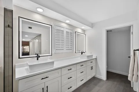 a bathroom with a shower and a sink