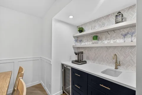 a kitchen with a sink a stove and cabinets