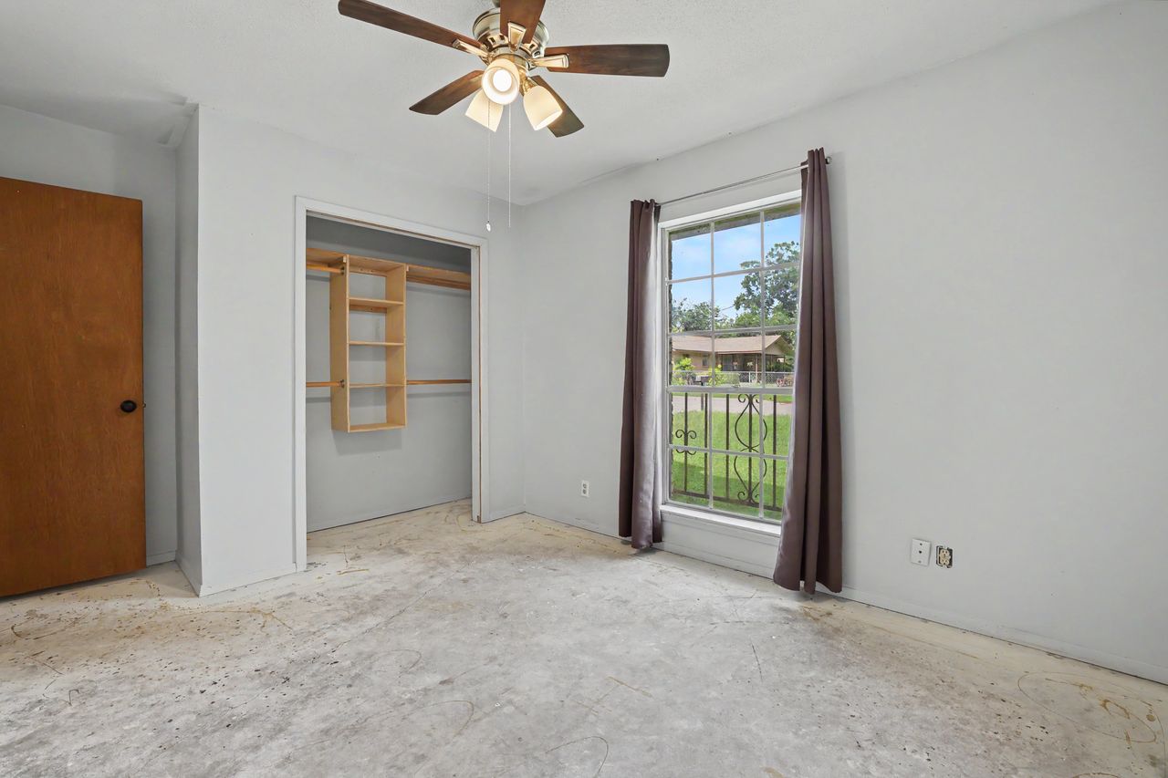 1811 Terry Lane Georgetown, TX 78628 - Photo 28 of 40 A quiet bedroom with a ceiling fan and a built-in closet, ready for your personal touch.