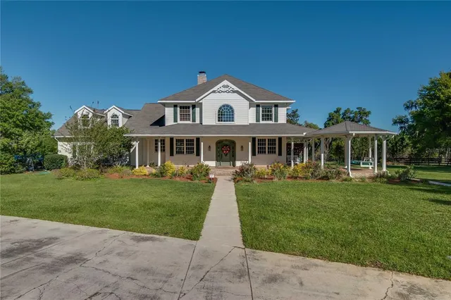 a view of a green field with wooden fence