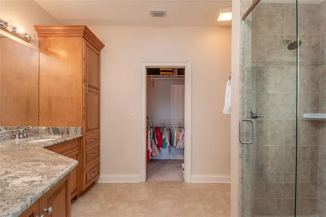 a view of a wooden house with a patio and a yard