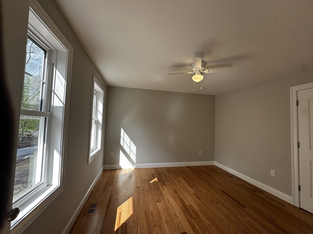 56 Dudley Road Billerica, MA 01821 - Photo 15 of 29 a view of an empty room with wooden floor and a window