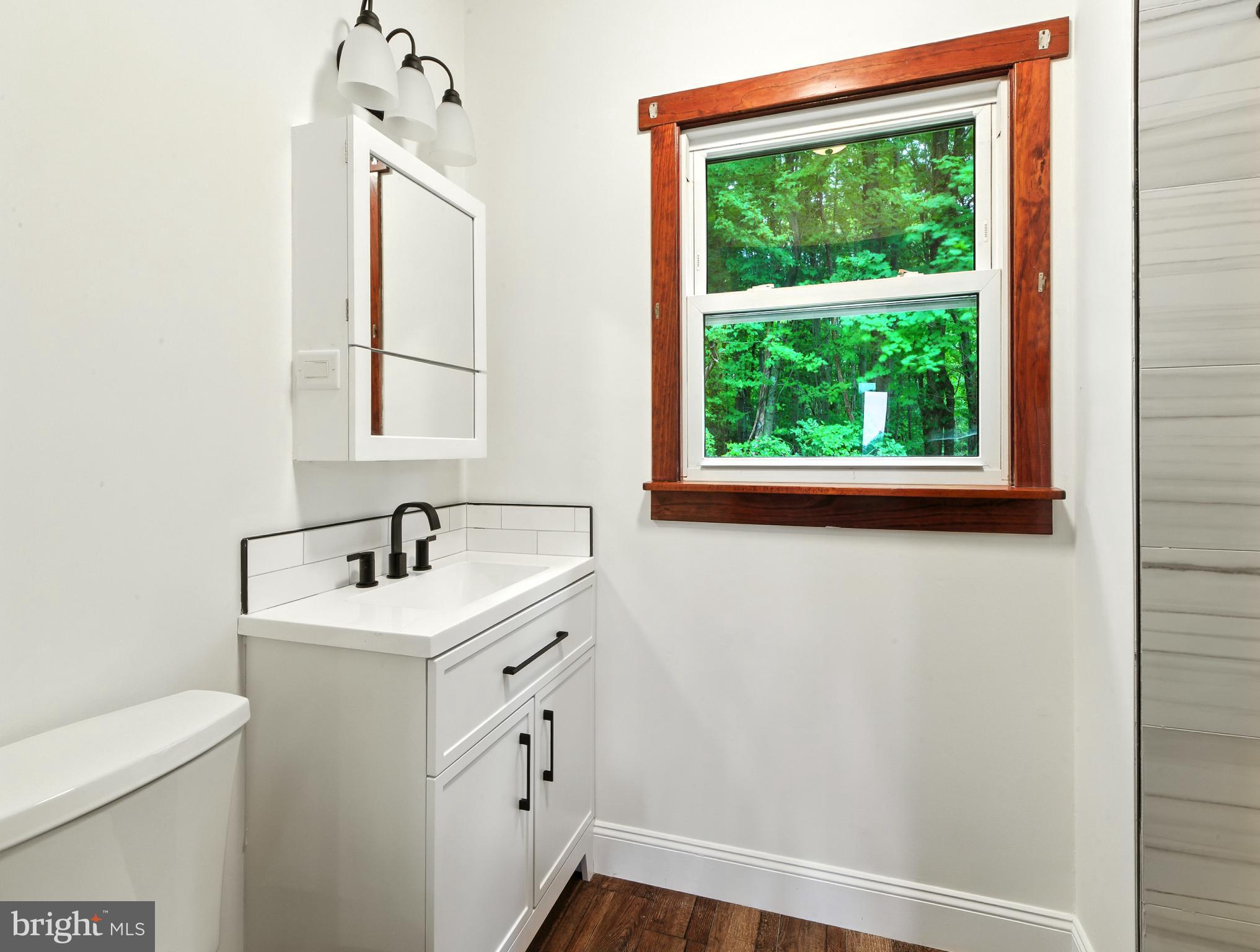 640 Mantua Boulevard Sewell, NJ 08080 - Photo 10 of 25 a bathroom with a sink a toilet and a window