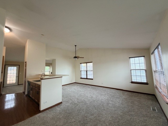 2418 Oneida Lane, Unit 2418 Naperville, IL 60563 - Photo 6 of 21 an empty room with windows and fireplace