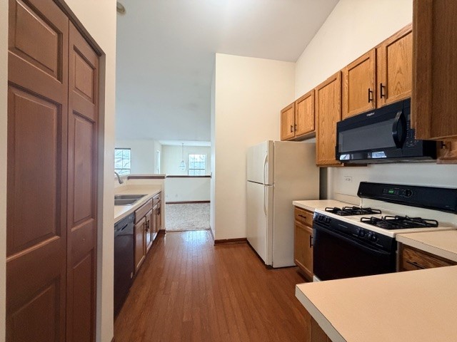 2418 Oneida Lane, Unit 2418 Naperville, IL 60563 - Photo 9 of 21 a kitchen with stainless steel appliances a microwave a stove a sink dishwasher a refrigerator white cabinets and wooden floor