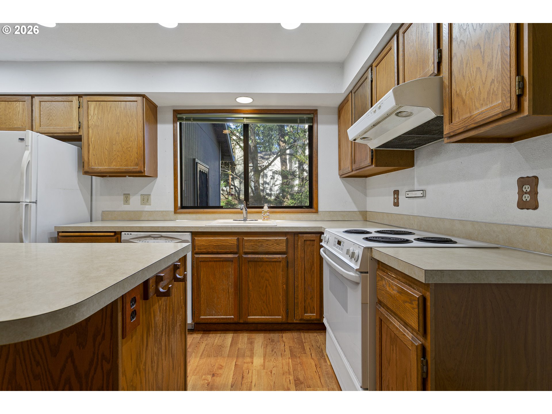 10410 Southwest 25th Avenue Portland, OR 97219 - Photo 21 of 39 a kitchen with a stove and a sink
