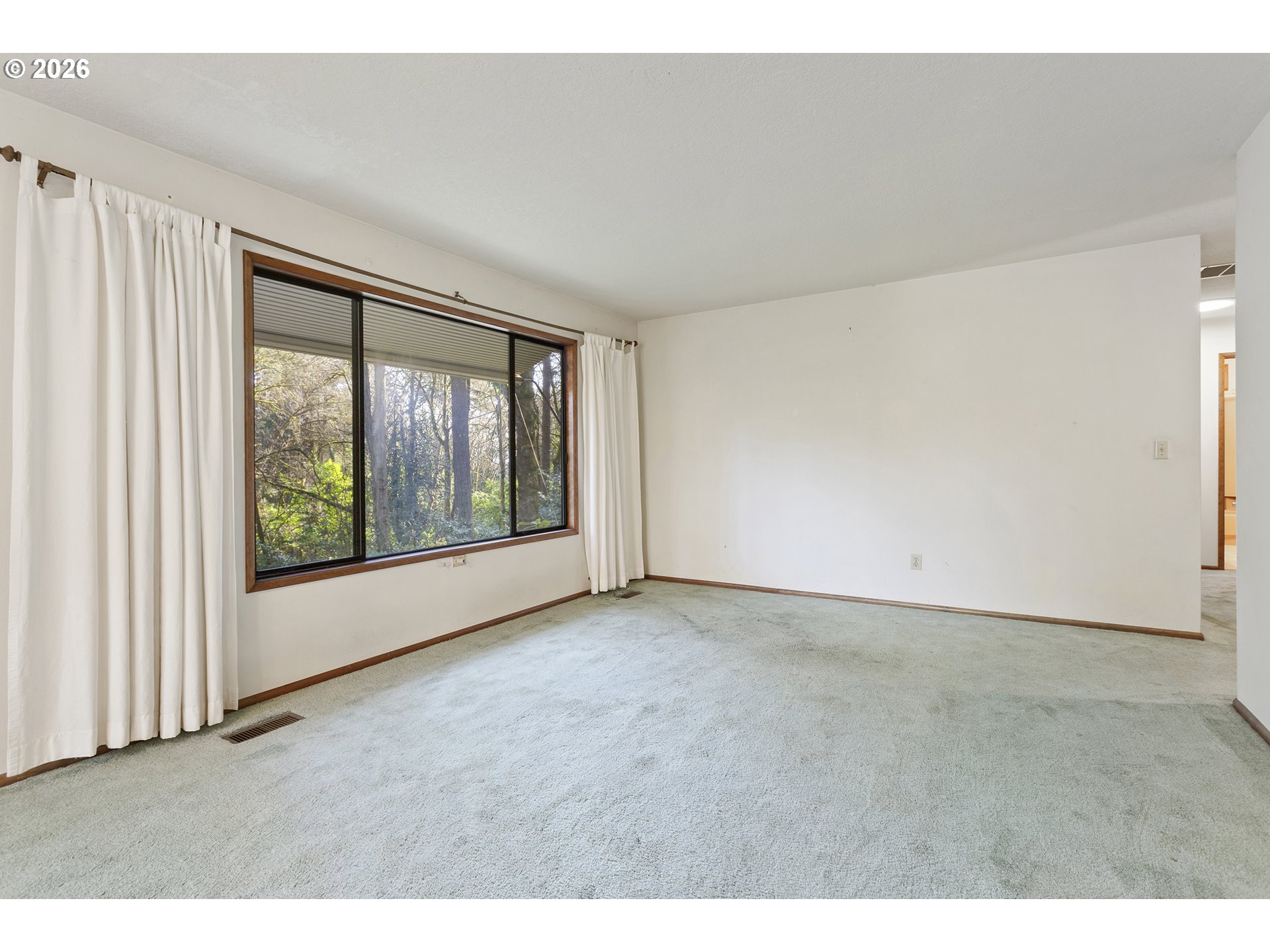 10410 Southwest 25th Avenue Portland, OR 97219 - Photo 23 of 39 a view of an empty room with a window