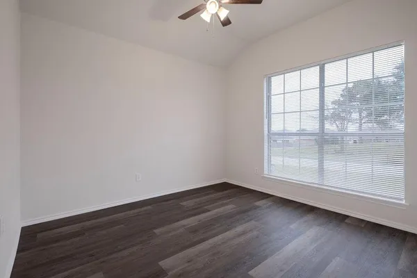 a bathroom with a sink a toilet a mirror a vanity and bathtub