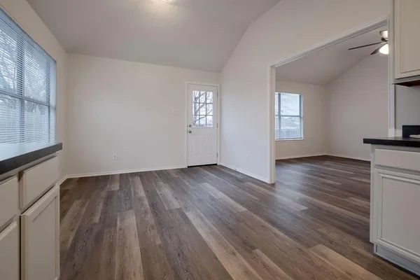 a kitchen with stainless steel appliances granite countertop a stove microwave and cabinets