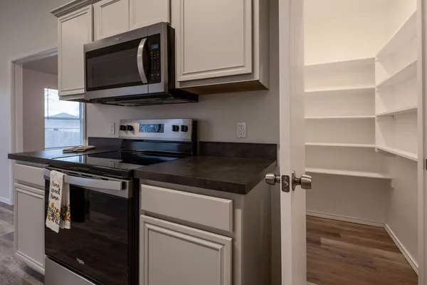 a kitchen with granite countertop a sink and a window