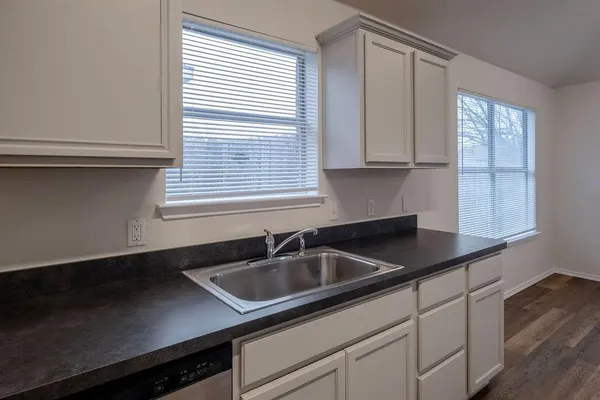 a kitchen with stainless steel appliances a stove sink and cabinets