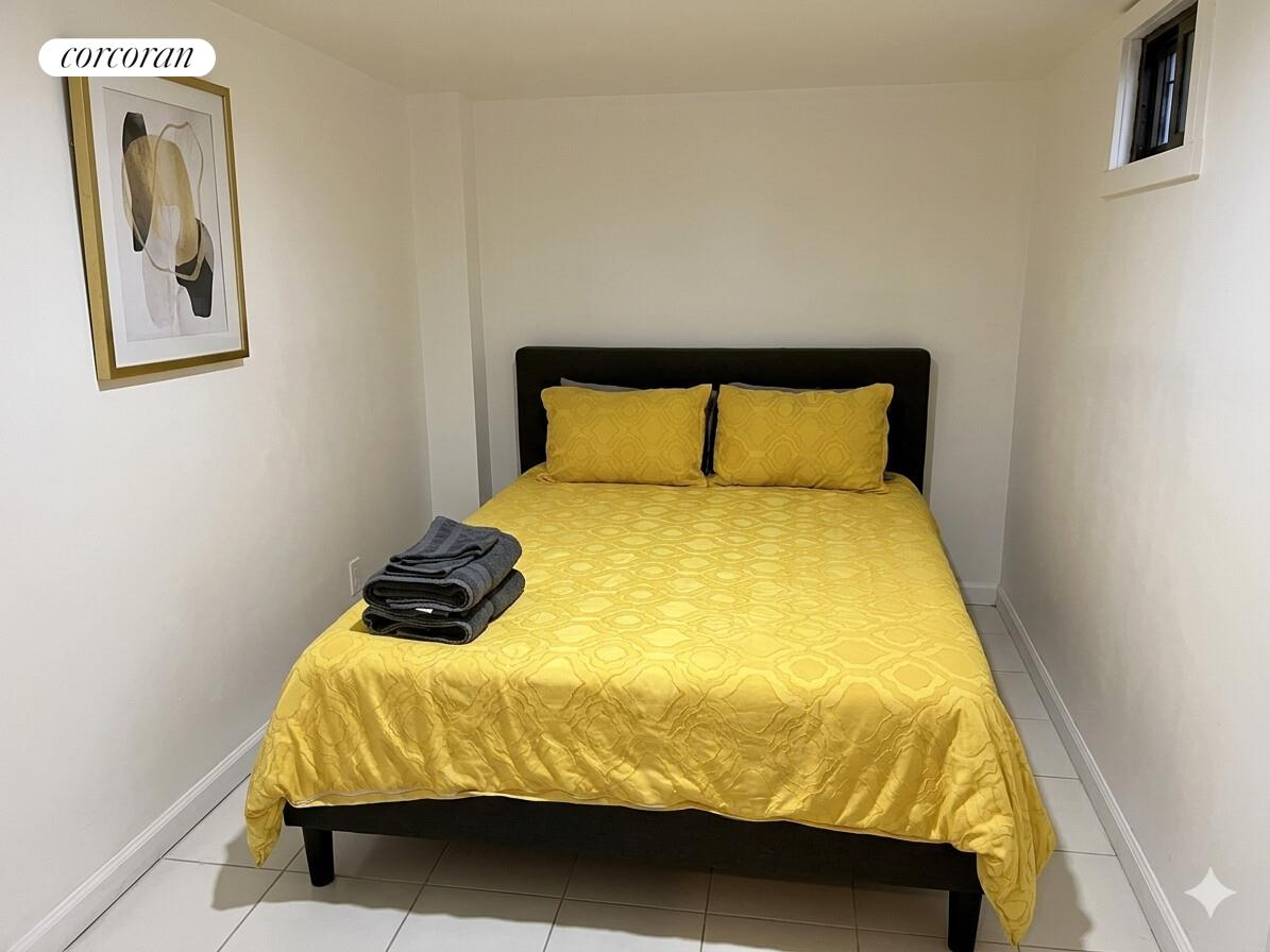 487 Hart Street Brooklyn, NY 11221 - Photo 13 of 19 a bedroom with a bed and painting on the wall