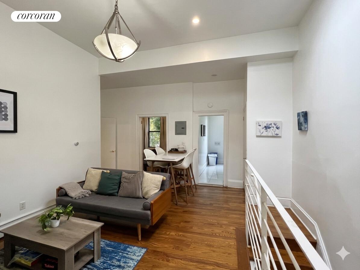 487 Hart Street Brooklyn, NY 11221 - Photo 14 of 19 a living room with furniture and a wooden floor