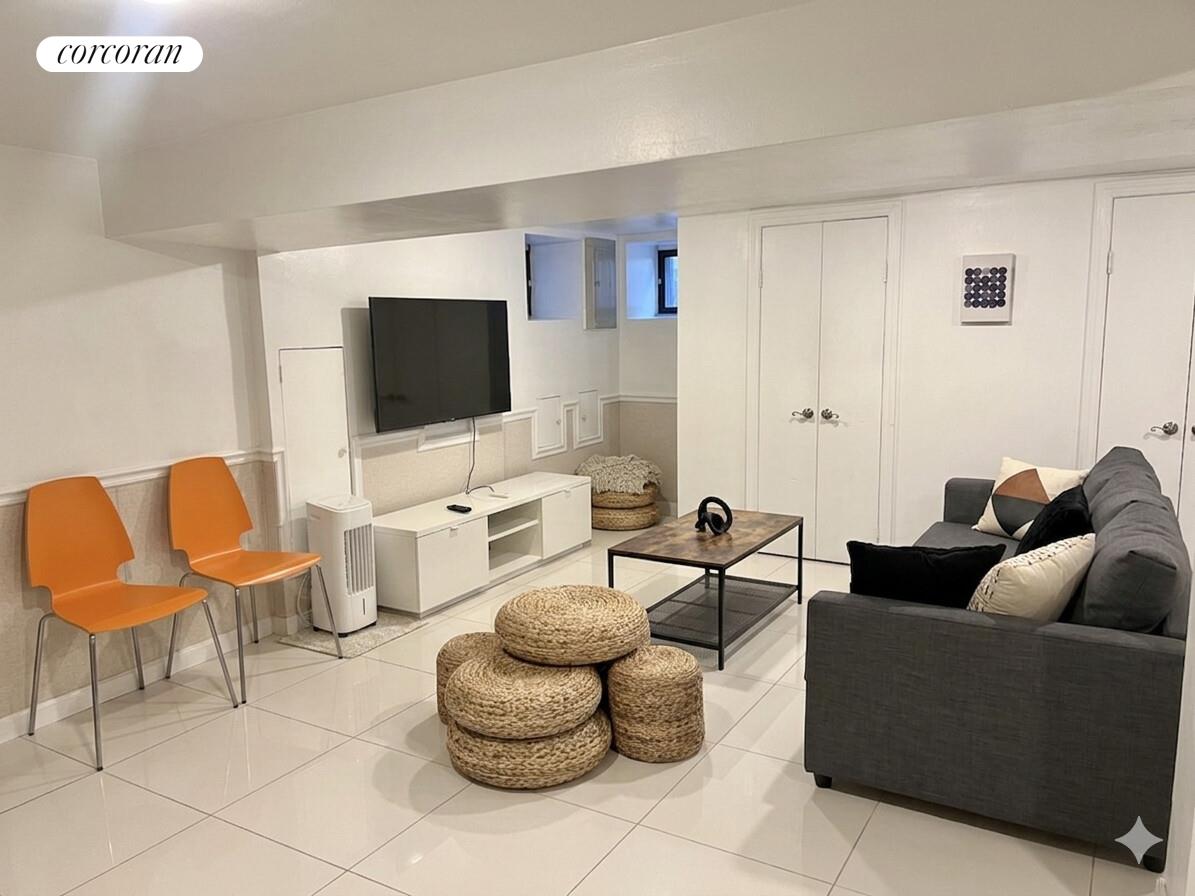 487 Hart Street Brooklyn, NY 11221 - Photo 16 of 19 a living room with furniture and a flat screen tv