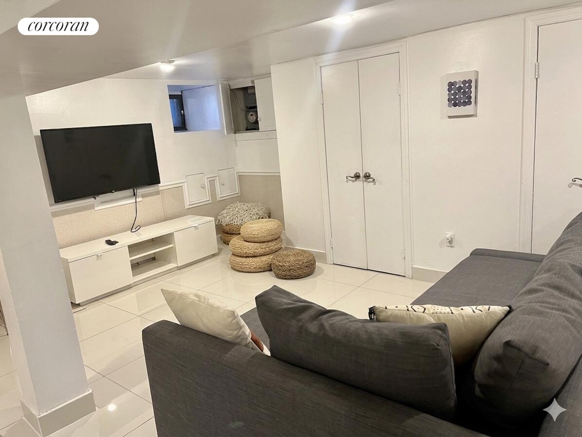 487 Hart Street Brooklyn, NY 11221 - Photo 18 of 19 a living room with furniture and a flat screen tv