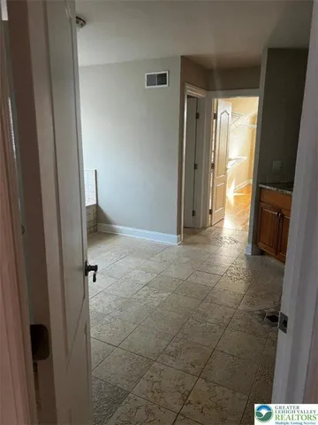 a view of hallway with wooden floor