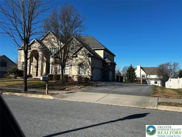 a view of a building with snow on the road