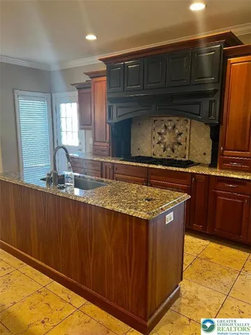 a kitchen with granite countertop a stove and cabinets