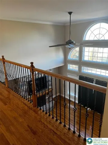 a view of staircase with railing and wooden floor