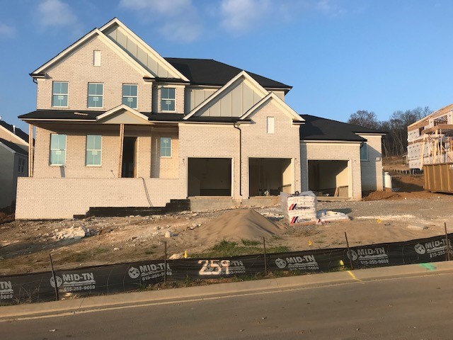 720 Sedley Road Nolensville, TN 37135 - Photo 1 of 14 a view of a white house with large windows next to a road