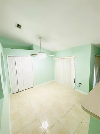 a kitchen with a sink a stove top oven a refrigerator and a dining table