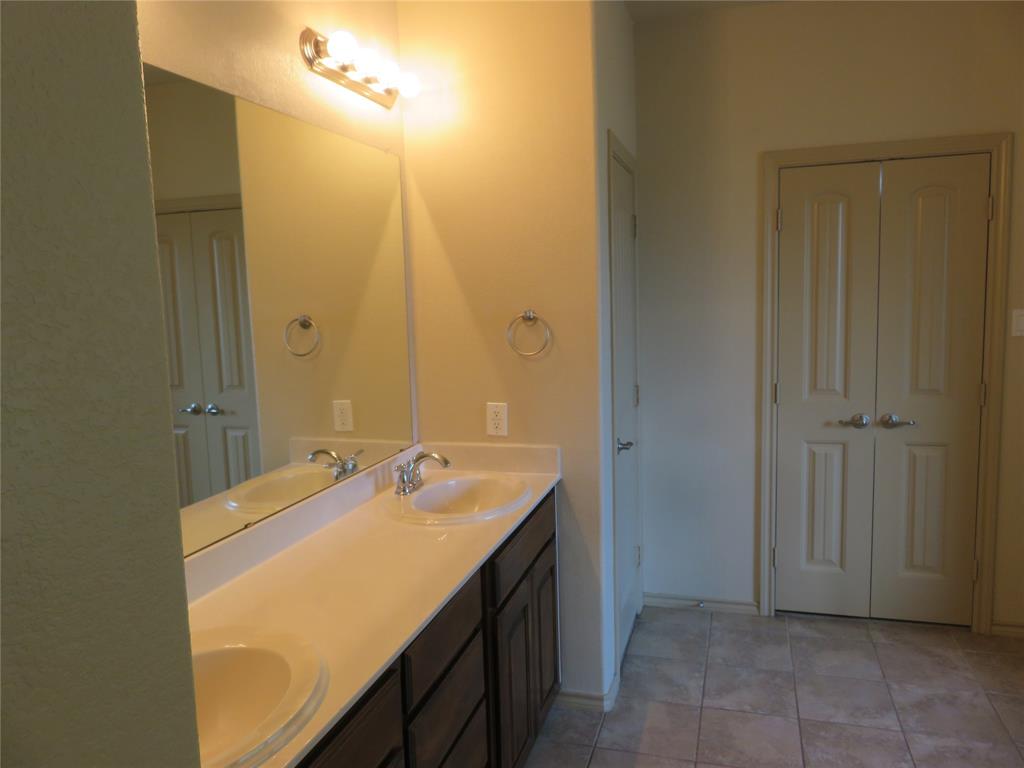 1122 Walter Stephenson Road Midlothian, TX 76065 - Photo 19 of 26 Double vanity featuring undermount sinks, chrome faucets, and a light-toned countertop