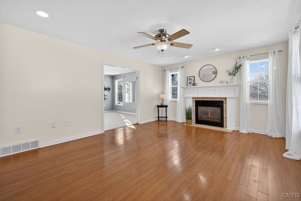 4326 Chilmark Street Marcellus, NY 13108 - Photo 12 of 49 Gas fireplace with freshly painted walls and a cle