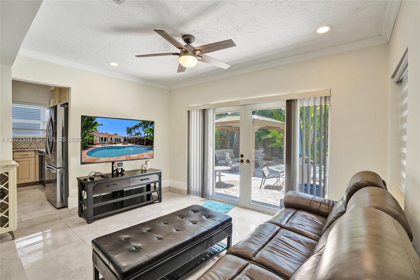 811 Northeast 73rd Street Miami, FL 33138 - Photo 15 of 51 a living room with furniture and a flat screen tv