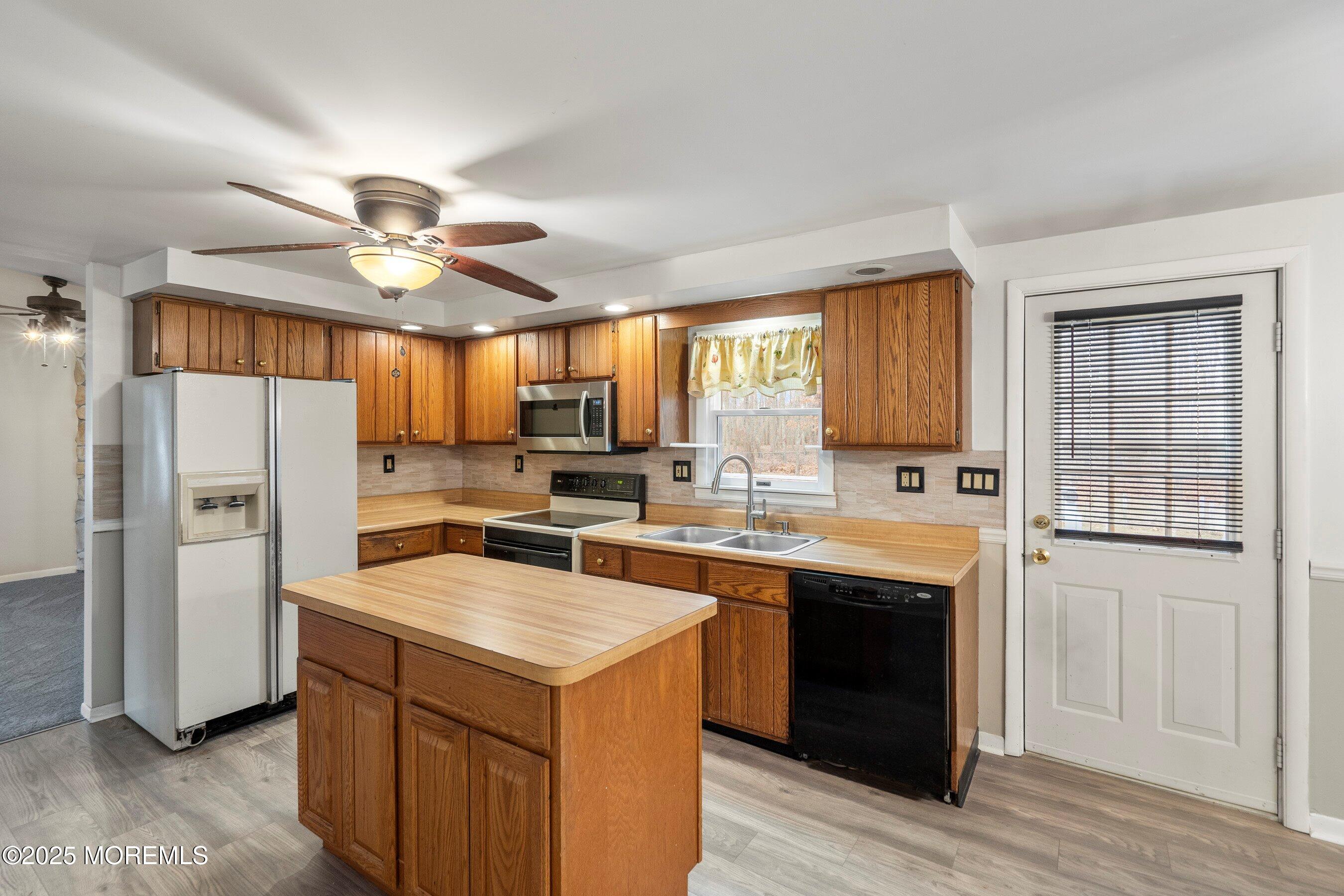581 Sergey Road Jackson, NJ 08527 - Photo 8 of 38 a kitchen with a sink a counter top space stainless steel appliances cabinets and a window