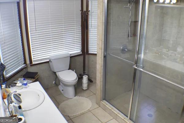 a bathroom with a toilet and a shower