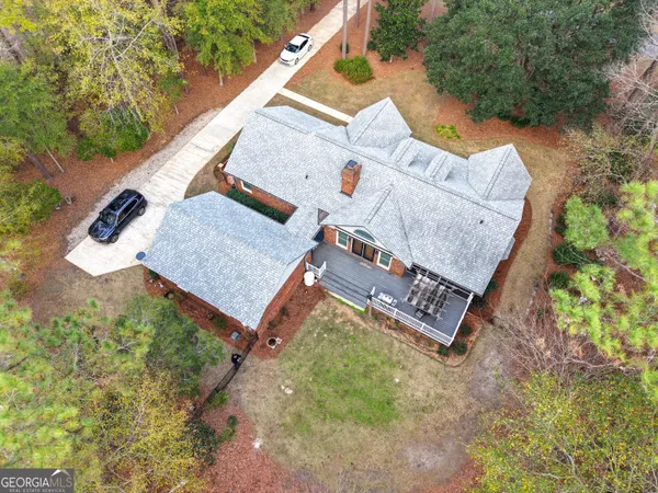 an aerial view of a house with yard