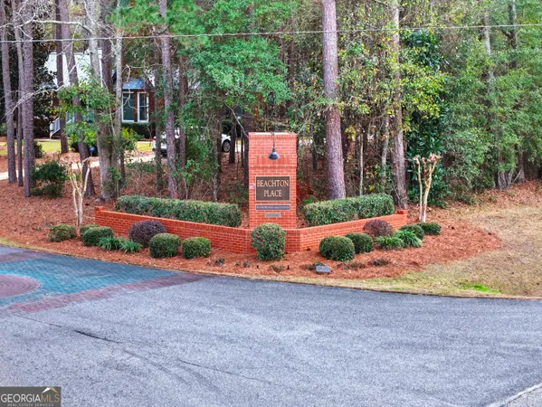 front view of a house with a yard and potted plants