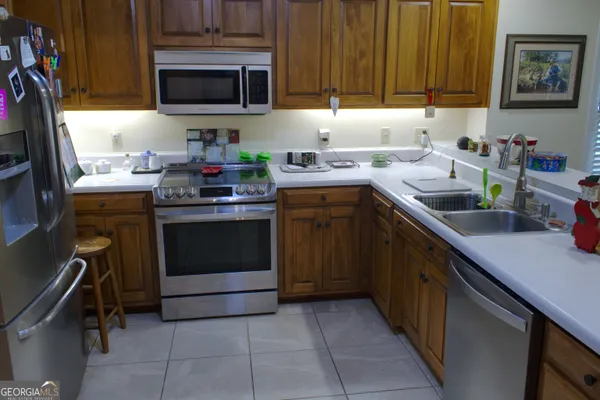 a kitchen with stainless steel appliances a stove sink and cabinets