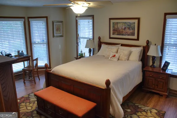 a bed room with a bed and a painting on the wall