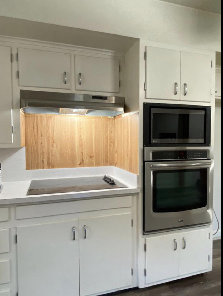 3505 46th Street Lubbock, TX 79413 - Photo 8 of 9 a kitchen with granite countertop white cabinets and stainless steel appliances