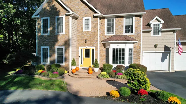 a front view of house with yard and green space