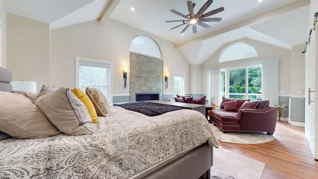 a spacious bathroom with a tub sink and mirror