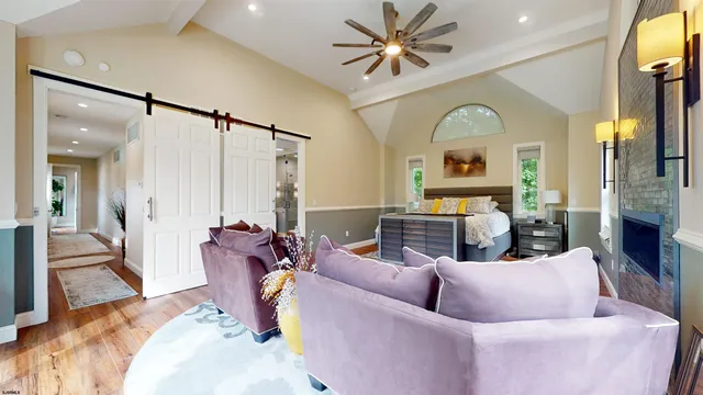 a bedroom with a bed and a flat tv screen on dresser