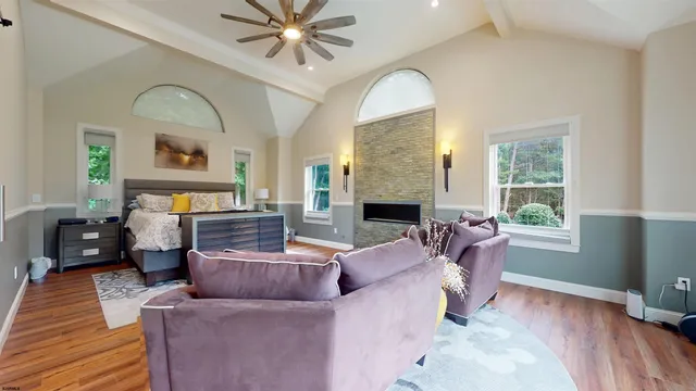 a bedroom with bed and large windows